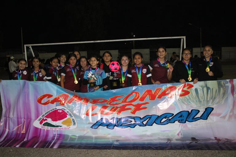 Group of young athletes standing behind a colorful sports banner at an outdoor event or competition