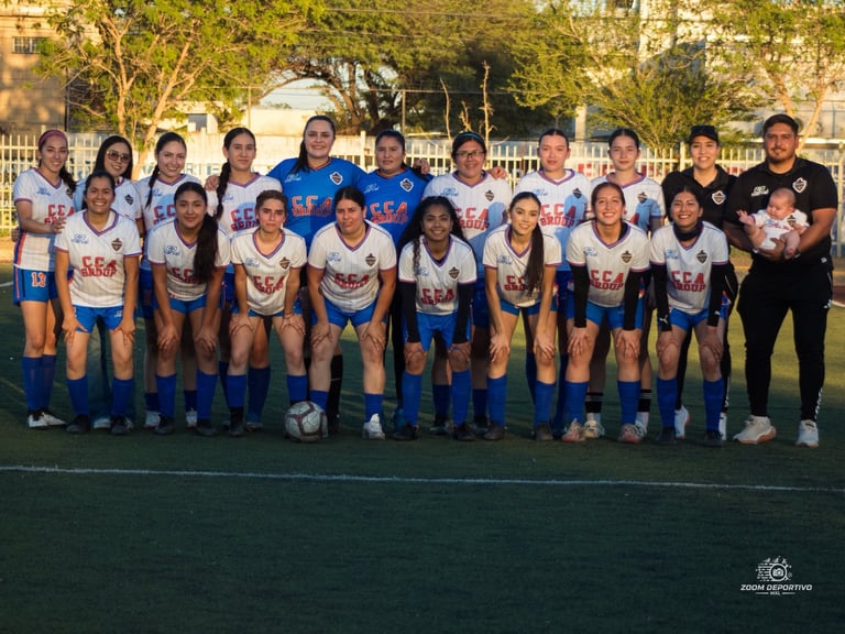 Youth soccer team in blue and white uniforms posing with coaches on a field