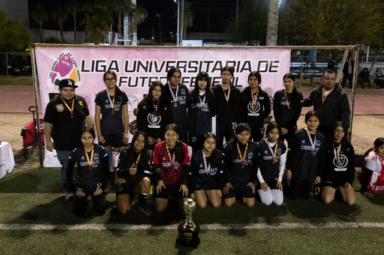 University football team celebrating with trophy and medals at Liga Universitaria de Futbol event