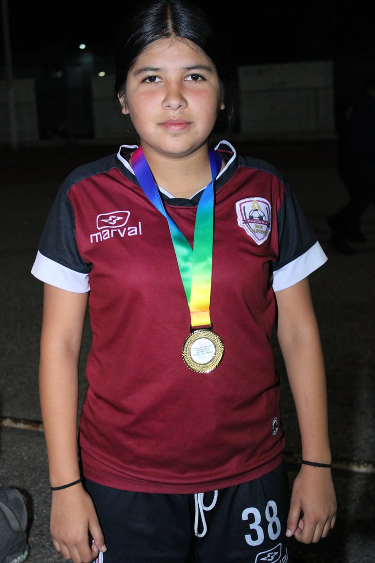 Young athlete in maroon and black sports jersey wearing a gold medal with rainbow ribbon around neck