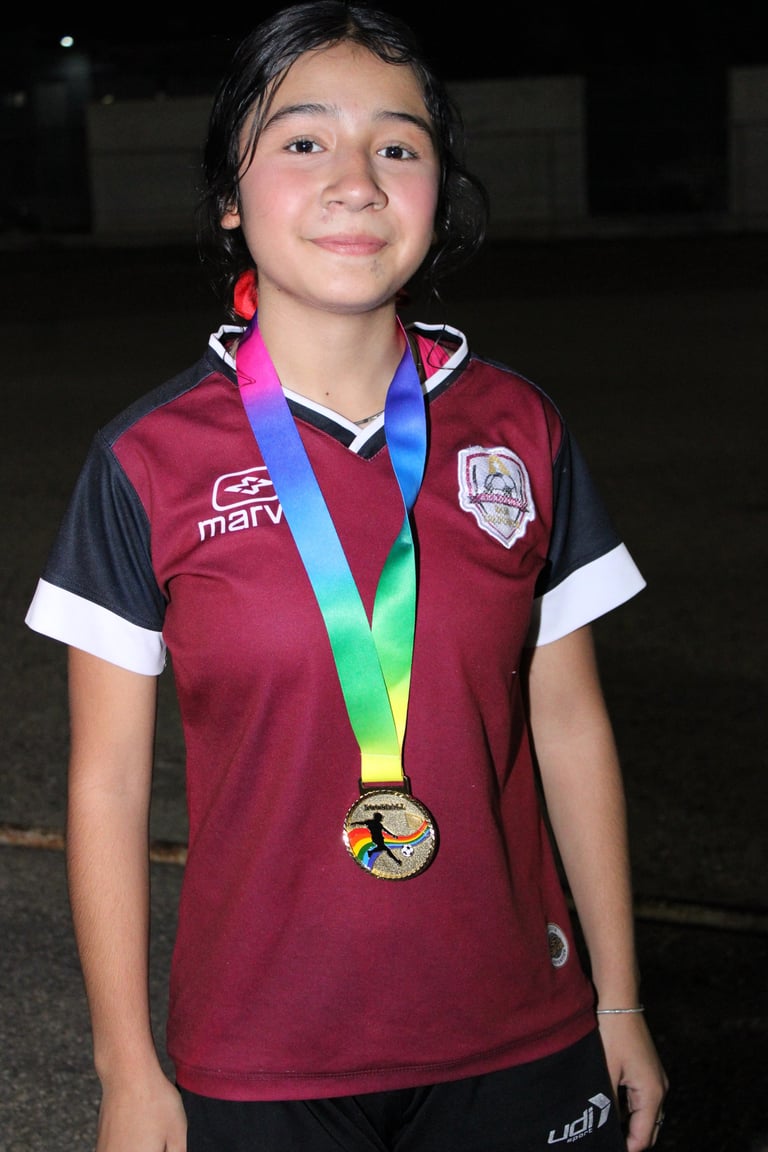 Young athlete in maroon sports jersey wearing colorful medal around neck, smiling at camera